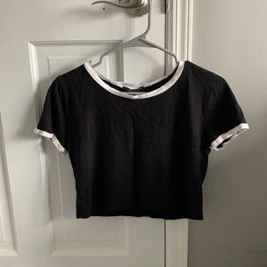 Black crop top with white around neck and arms
